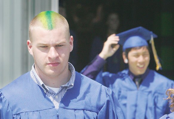 By Greg Farrar Nate Williams removes his graduation cap to reveal painted stripes on his hair after the end of Hazenâs commencement exercises.