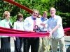Newcastle Mayor Ben Varon and Communications Director Doug Alder get into place to cut the ribbon at the May Creek Bridge opening ceremony Thursday. - By Adam Eschbach 
