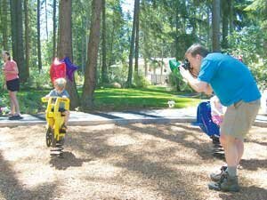 windtree-park-newc-20080712 Matt Dalton takes a photo of his son Kai, 3, during the opening of Windtree Park last month. For more on the new park, see story, page 12. Photo by Jim Feehan