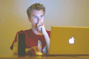 movie-arts-bell,a-20090600 Alex Bell, a Liberty High School graduate, works on a home movie project from his laptop, a skill that helped get him accepted to the University of Southern California film school. Contributed