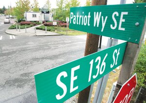 By Christina Corrales-Toy The long road toward Liberty High School officially bears a rather appropriate name, after new Patriot Way Southeast signs were installed Sept. 6. The name change for the road formerly known as 168th Avenue Southeast was approved by the King County Council in June after students from the Liberty Associated Student Body, along with support from the school’s dean of students Michelle Munson and school resource officer Dave Montalvo, paved the way to make it happen. “A lot of folks worked really hard the last year, including members of every class and graduated seniors, to go through a really tough government process,” King County Councilman Reagan Dunn said, addressing the school at a Sept. 6 assembly. That work included filing paperwork with the county and spending rainy weekends knocking on doors and getting neighbors’ approval for the name change. Students from the Liberty ASB leadership class began the process in September 2012, with no guarantee that the King County Council would approve the change, despite all of the work they did, Principal Josh Almy said. “I’m not going to tell you that it was an easy process,” he said at the assembly. There was an initial battle among the council to get the name changed, Dunn told the students, citing concerns that neighbors may have had with the process of updating their addresses, but the King County Council unanimously approved the new name in June. “Ultimately, they saw the vision of changing the name of the front road out here to Patriot Way,” he said. Dunn, who sponsored the legislation making the change a reality, commended the Liberty students’ initiative to pursue the name change, and encouraged them to continue to remain active in the community. “In a few short years, all of you will be voting, and this is your community,” he said at the assembly. “The future is in your hands and this kind of activity, the kinds of things that make a difference, I encourage you to keep doing in your community.”