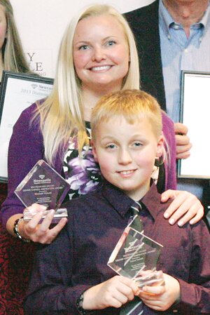 By Greg Farrar Elizabeth Widseth and son Trevor Yarnell hold their Diamond Award in November.
