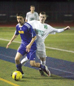 By Greg Farrar Drew Wilson, Hazen High School freshman midfielder, and Liberty senior midfielder Tyler Jensen vie for the ball during the second period of their March 19 soccer match.