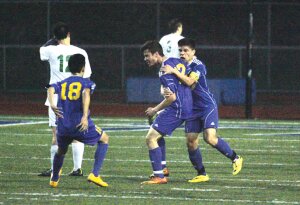 By Greg Farrar Zach Quensel (center), Hazen High School junior forward, celebrates his first-period goal with teammates Robbie Schroeder (18) and Reyes Garcia in their March 19 match against Liberty.